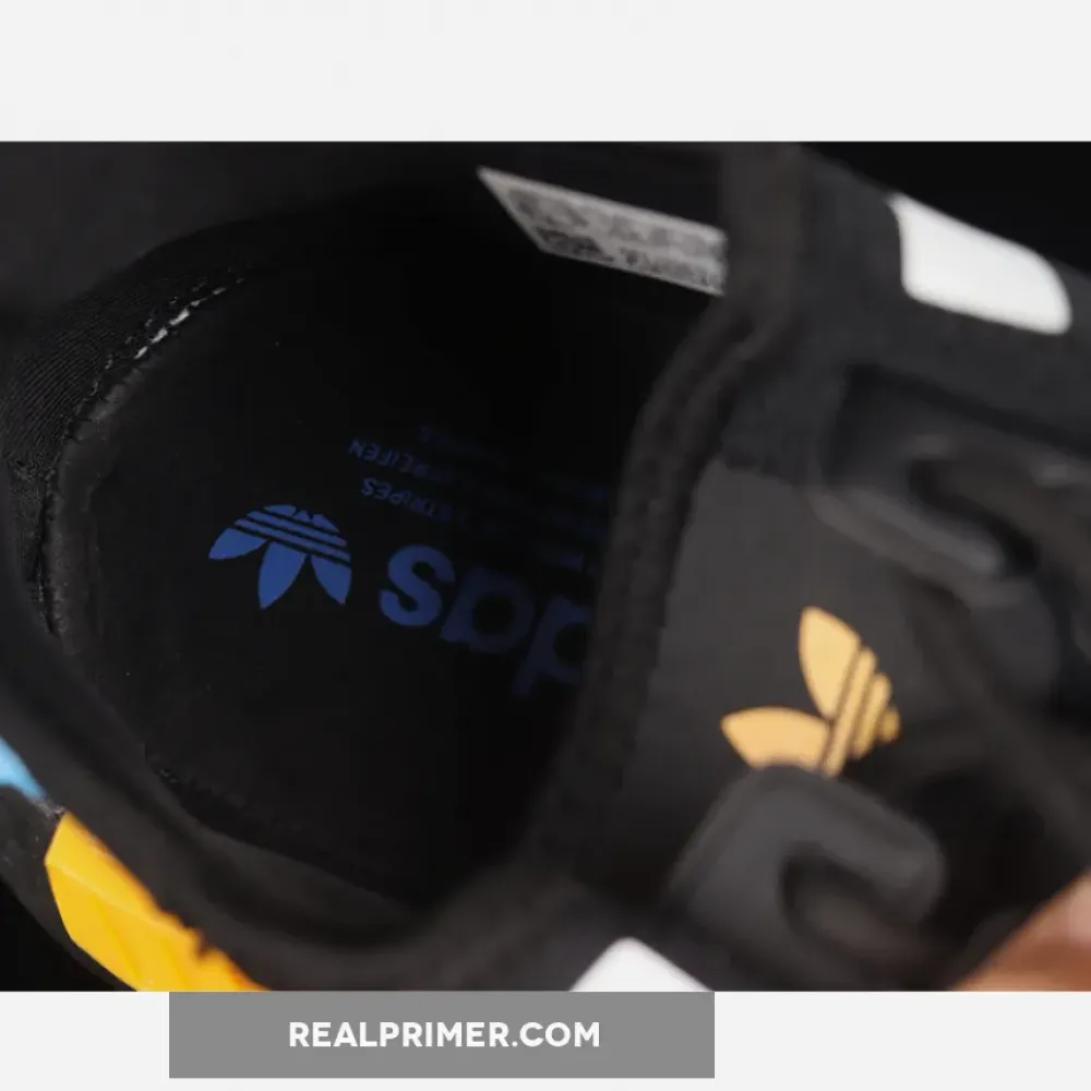 NMD_R1 SHOES CORE BLACK/CLOUD WHITE/COLLEGIATE GOLD FZ5876