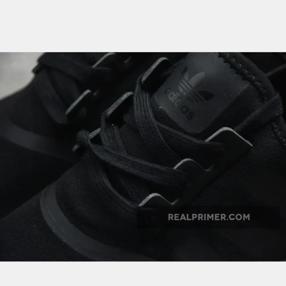 NMD_R1 SHOES CORE BLACK/CORE BLACK/GOLD METALLIC FV1787